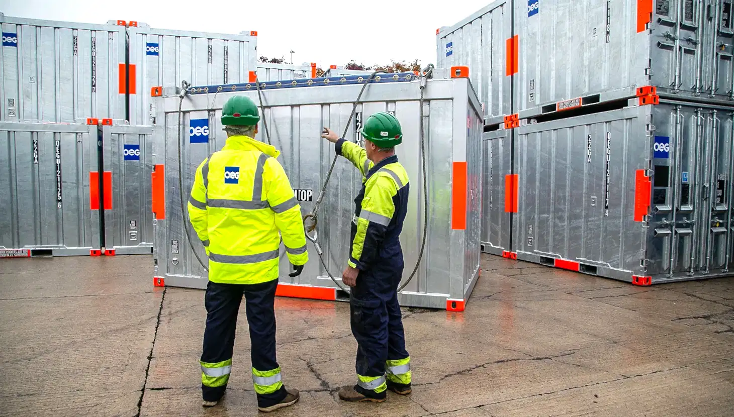 OEG workers in the Bridge of Don yard facing stacked containers