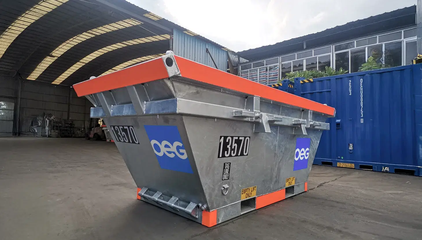 OEG hot dipped galvanised waste skip outside in workshop yard.