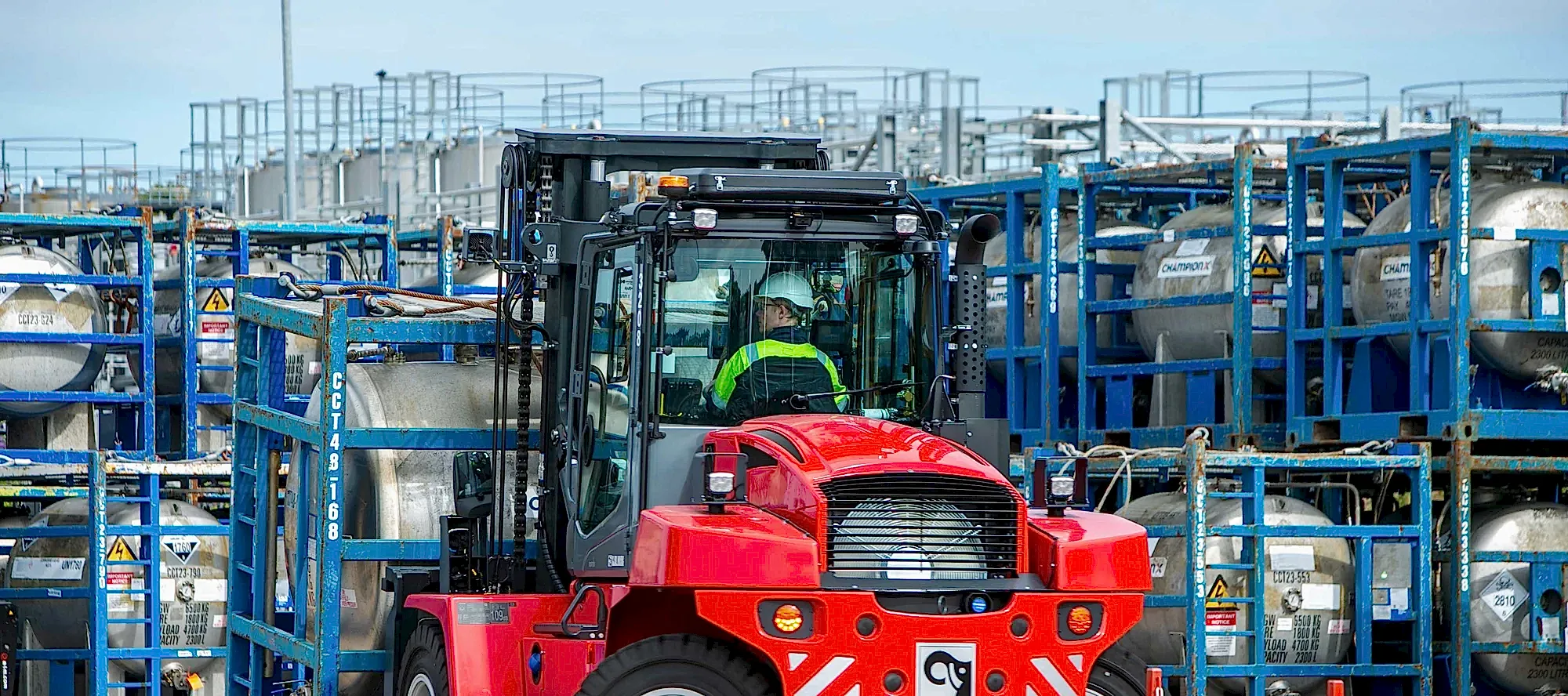 OEG chemical plant with red forklift transporting tanks