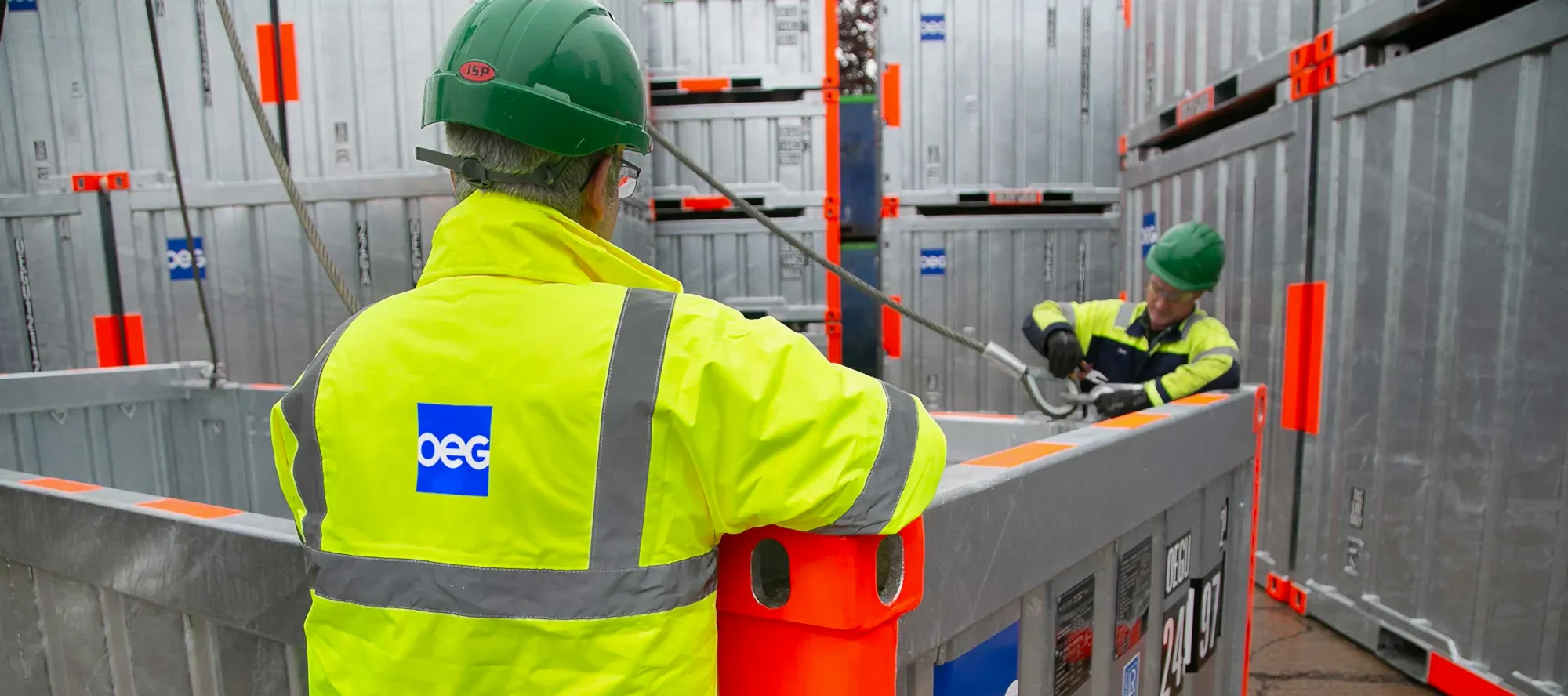OEG yard workers connecting slings to a container