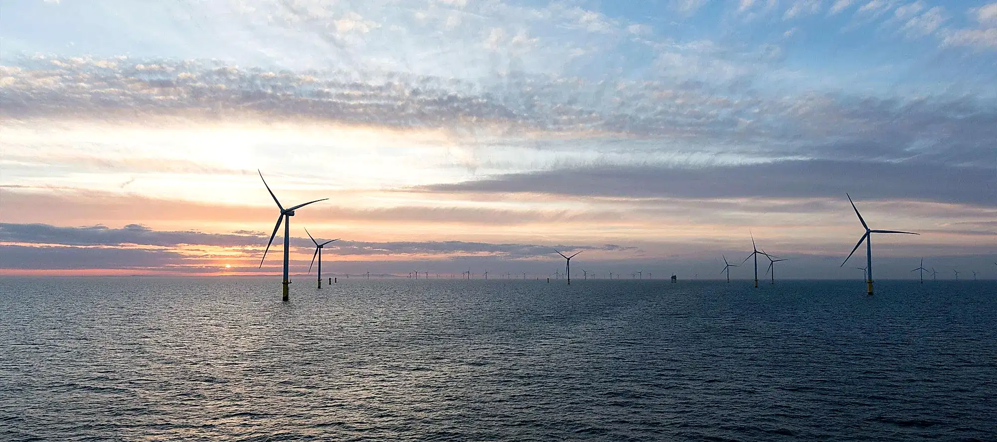 Wind turbines with sunset in background