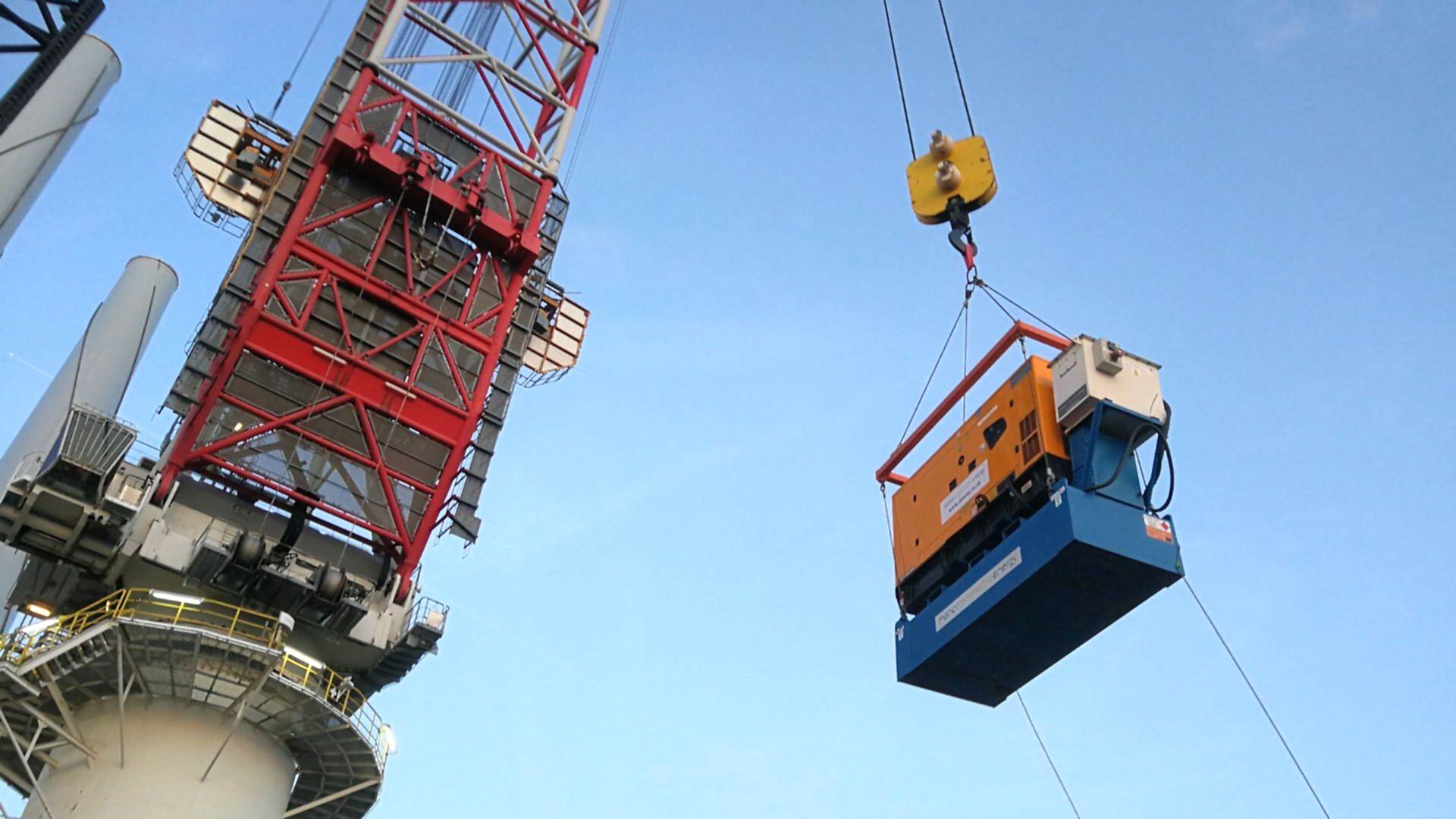 Temporary power unit being lifted by crane